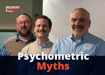 Three men stand together, smiling, with a backdrop featuring the text "Psychometric Myths." They are dressed in casual attire.