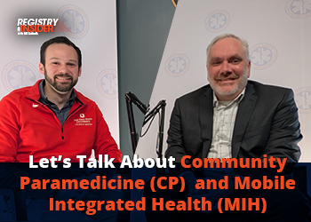 Two men sit together, discussing Community Paramedicine and Mobile Integrated Health, with microphones in front of them.