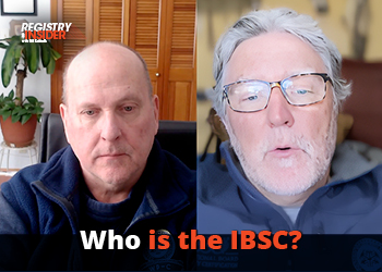 Two men are engaged in a video call, discussing the IBSC. One is wearing a dark jacket, and the other has glasses and light hair.